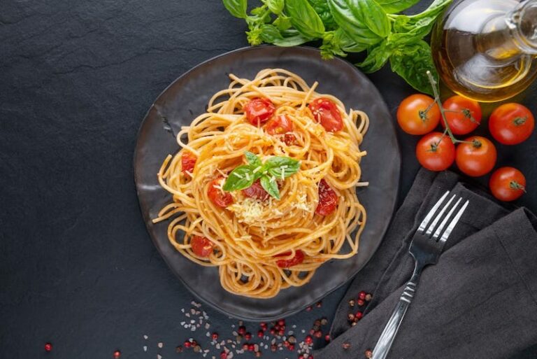 Plat de pâte spaghetti tomates sur fond noir - Pâtes IG haut - Freepik